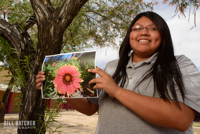 Photo by Bill Hatcher (Instagram: @bhatcherphoto). A girl of the Tohono O&rsquo;odham Nation in Sells, Arizona, shows a photograph of local flora.